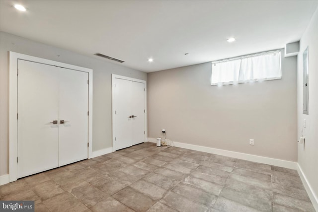 interior space with multiple closets and light tile patterned floors