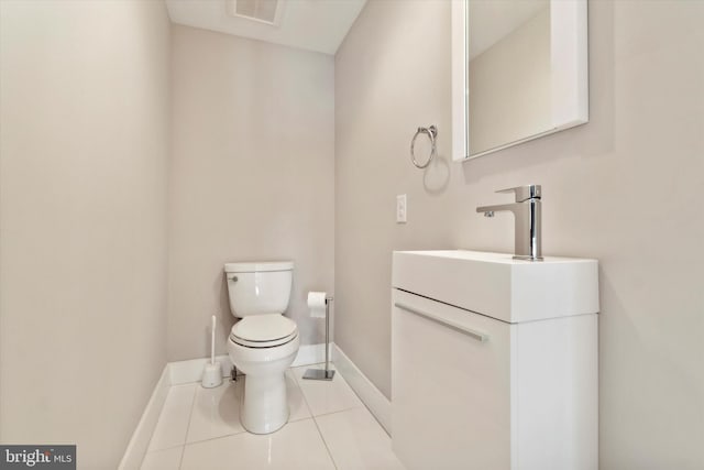 bathroom with tile patterned flooring, toilet, and vanity