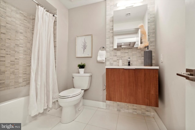 full bathroom featuring tile patterned flooring, shower / bath combo with shower curtain, vanity, and toilet