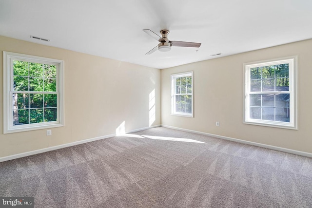 spare room featuring ceiling fan and light carpet