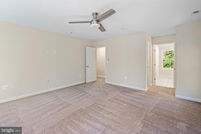 carpeted spare room with ceiling fan