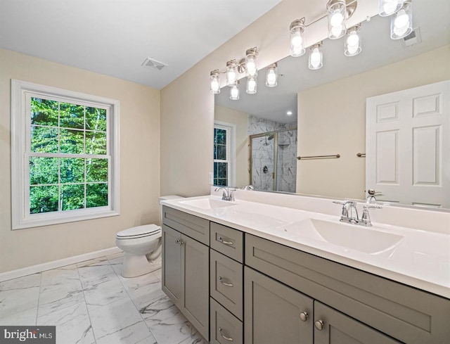 bathroom with vanity, toilet, and a shower with door