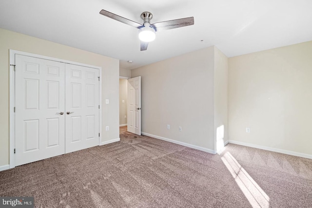 unfurnished bedroom featuring carpet flooring, ceiling fan, and a closet