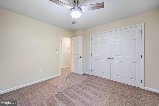 unfurnished bedroom with carpet flooring, ceiling fan, and a closet