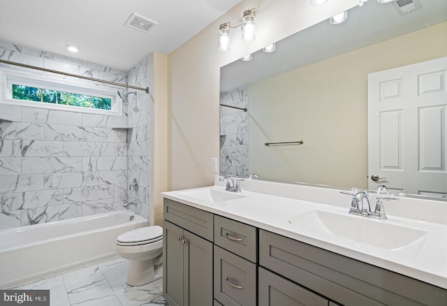 full bathroom with vanity, toilet, and tiled shower / bath