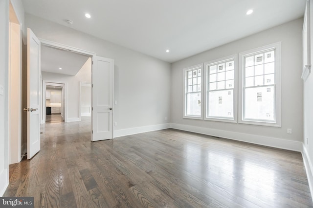 unfurnished room featuring dark hardwood / wood-style floors