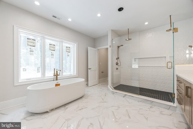 bathroom with vanity and separate shower and tub