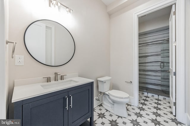 bathroom featuring vanity, toilet, and a shower with shower door