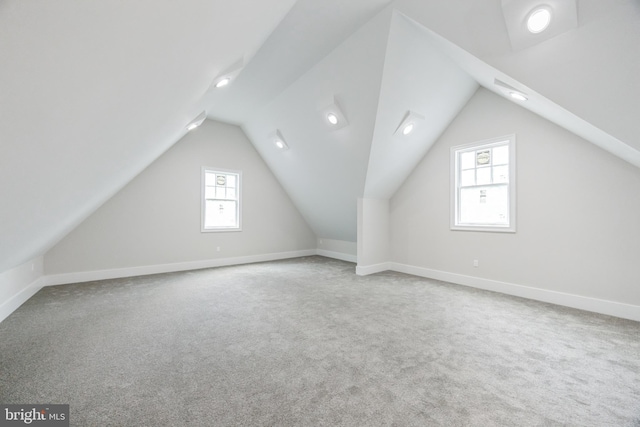 bonus room with carpet floors and vaulted ceiling