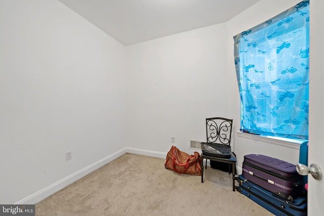 sitting room featuring light colored carpet