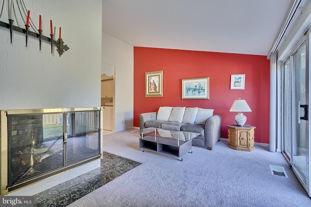 carpeted living room featuring plenty of natural light and vaulted ceiling