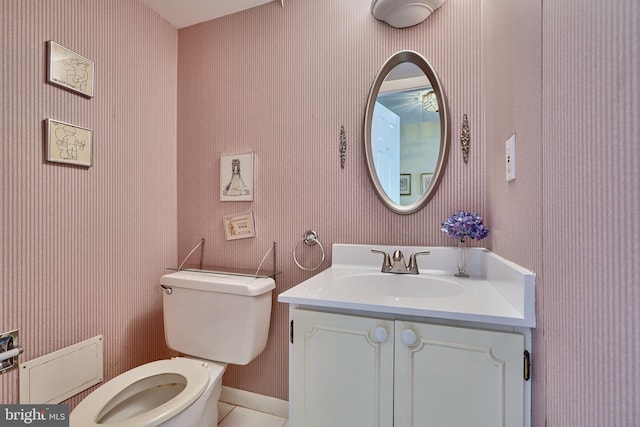 bathroom with vanity, tile patterned flooring, and toilet