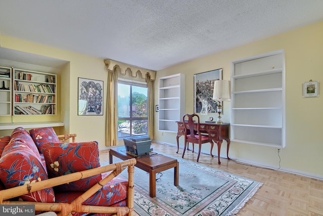 living room featuring light parquet flooring and a textured ceiling