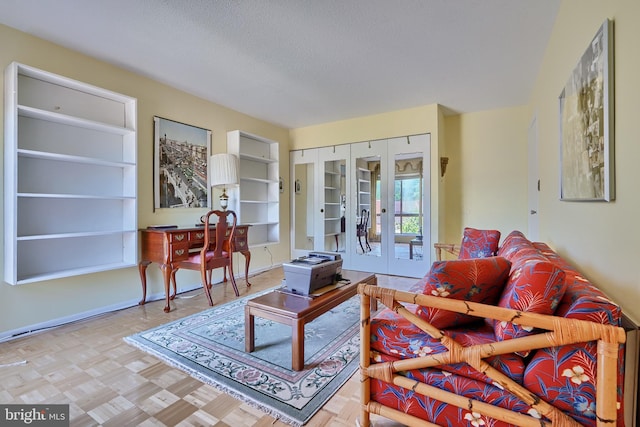 living room featuring french doors, light parquet flooring, and a textured ceiling