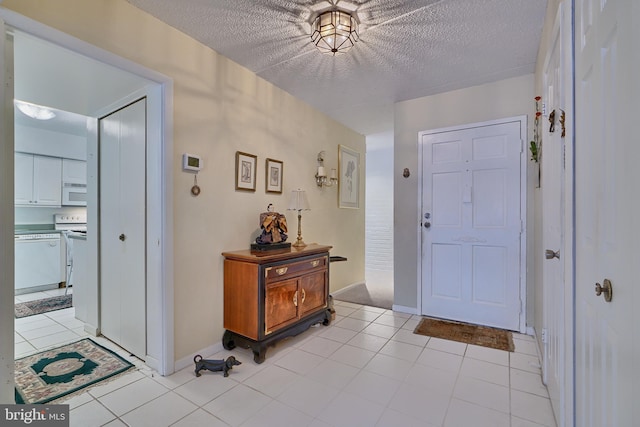 tiled entryway with a textured ceiling