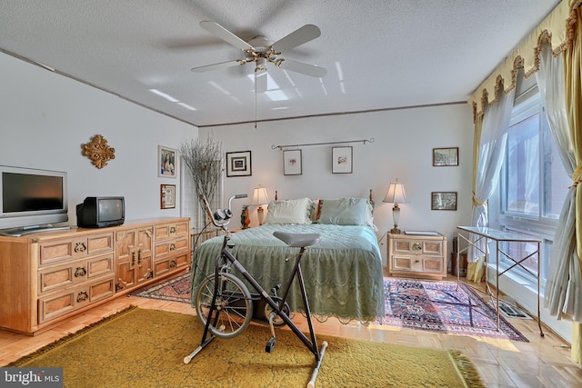 bedroom with a textured ceiling, ceiling fan, and hardwood / wood-style flooring