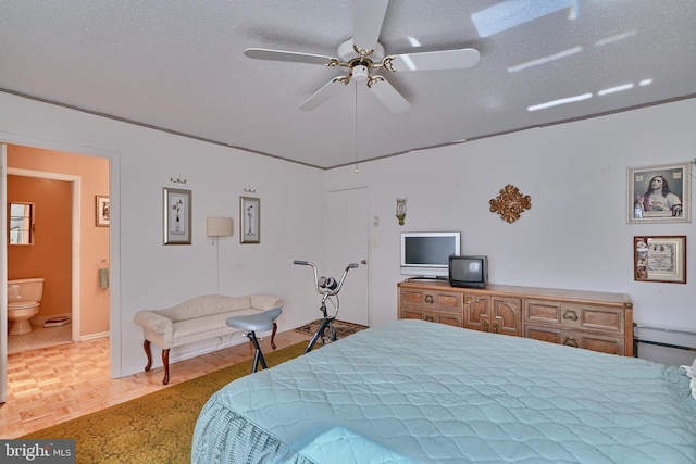 bedroom featuring a textured ceiling, light parquet flooring, ceiling fan, and connected bathroom