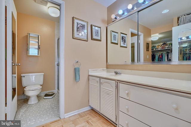 bathroom with vanity, toilet, and tile patterned floors