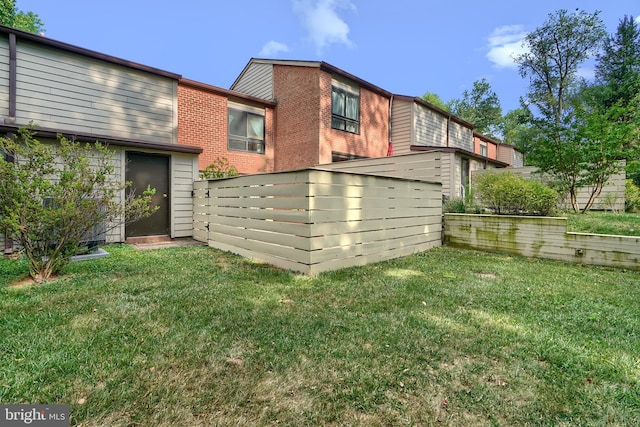 rear view of house with a lawn