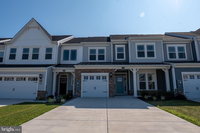 townhome / multi-family property featuring a garage and a front yard