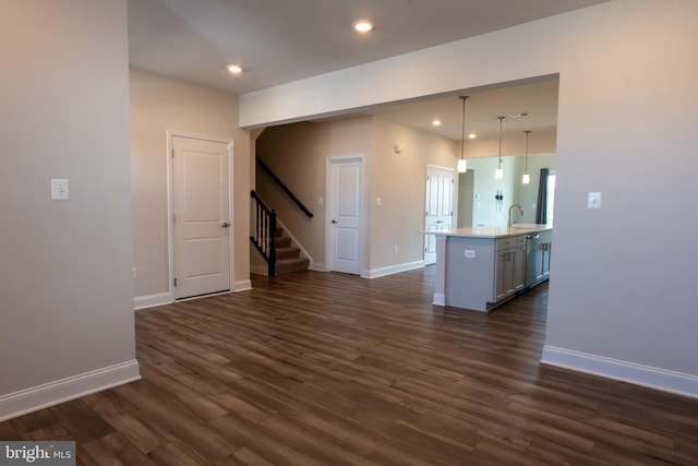 unfurnished living room with sink and dark hardwood / wood-style flooring