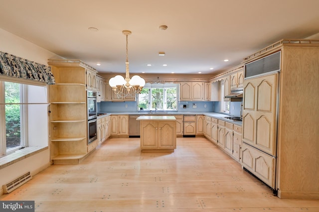 kitchen featuring light brown cabinetry, light wood-type flooring, stainless steel appliances, a notable chandelier, and pendant lighting