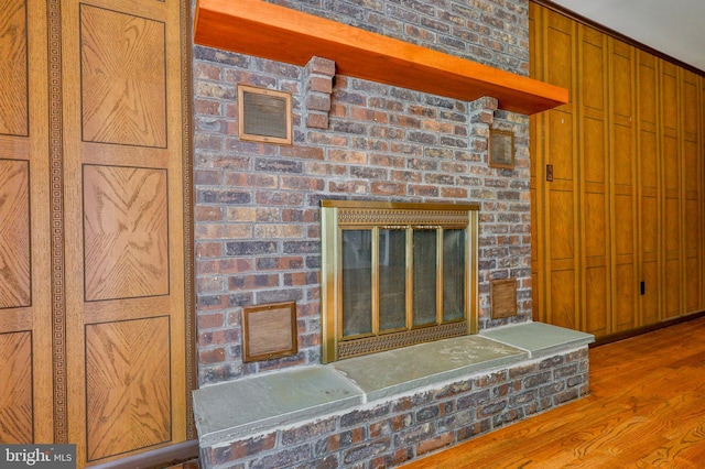 room details with hardwood / wood-style flooring and a fireplace