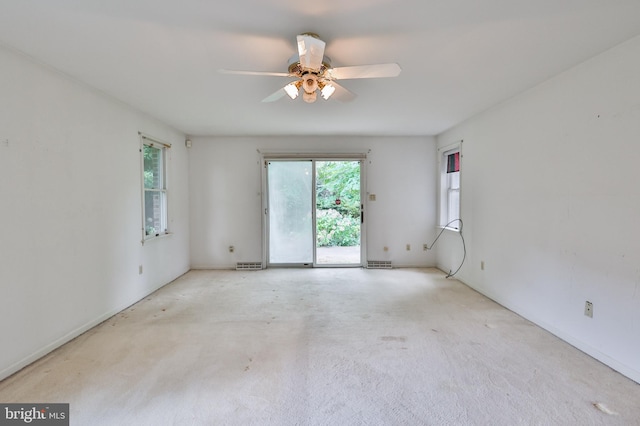 carpeted empty room featuring ceiling fan