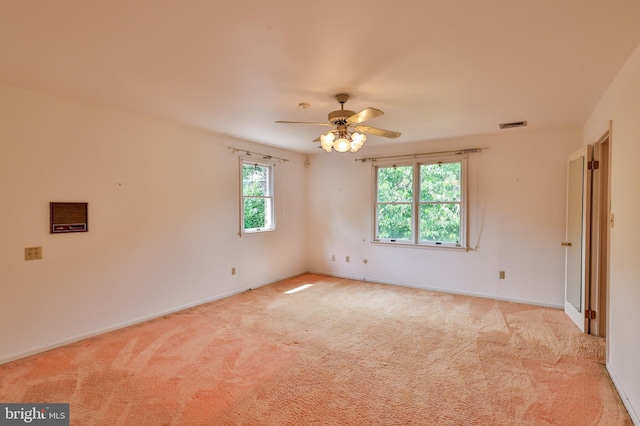 carpeted spare room featuring ceiling fan