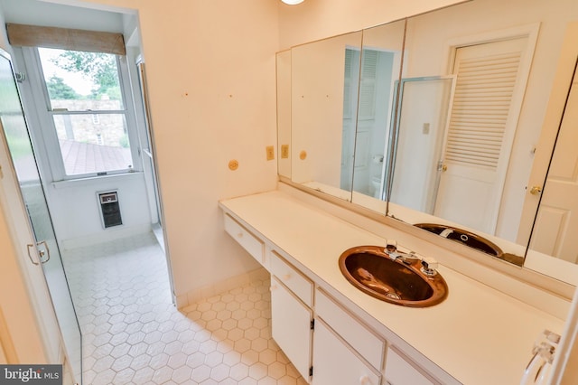 bathroom with vanity, walk in shower, and tile patterned flooring