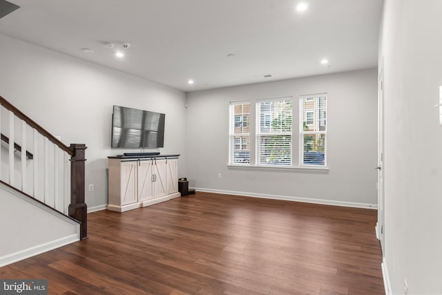 unfurnished living room with dark hardwood / wood-style floors