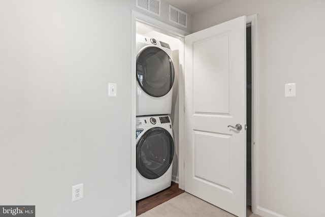 laundry room featuring stacked washing maching and dryer