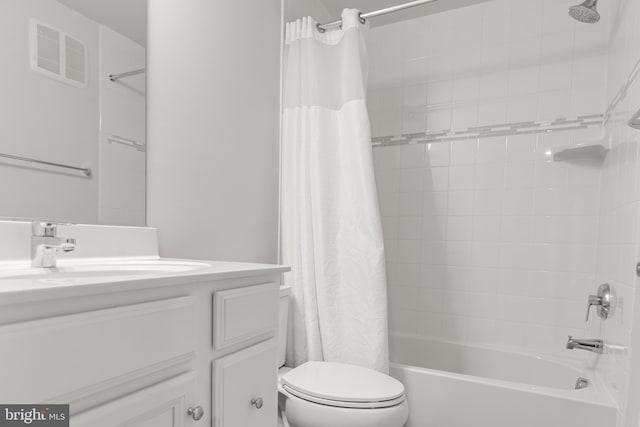 full bathroom with shower / tub combo with curtain, vanity, and toilet