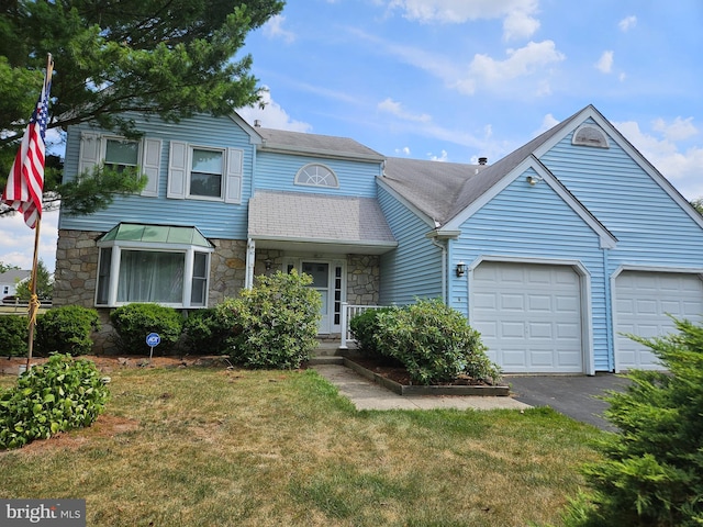 view of front of home with a garage and a front lawn