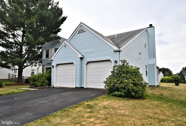 view of side of home featuring a yard and a garage