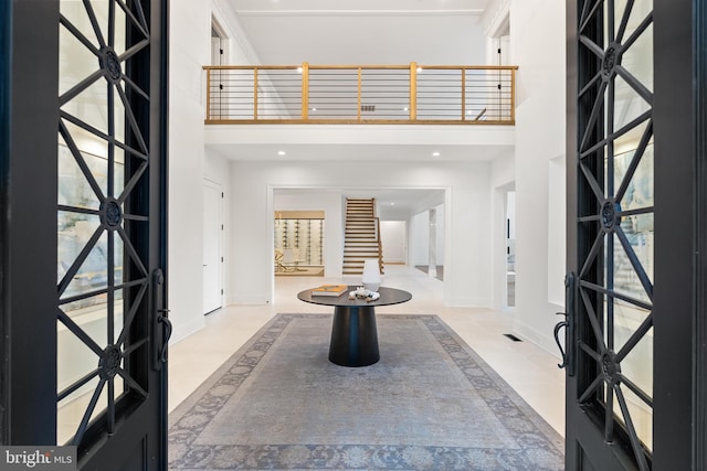 foyer with a towering ceiling