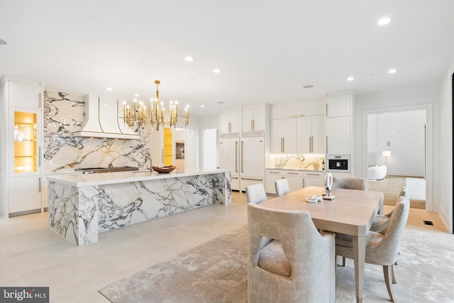 dining area featuring an inviting chandelier and light tile patterned flooring