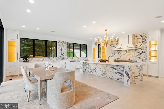 dining room featuring light tile patterned flooring and a notable chandelier