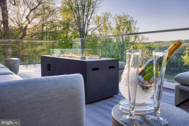 view of patio with an outdoor living space with a fire pit