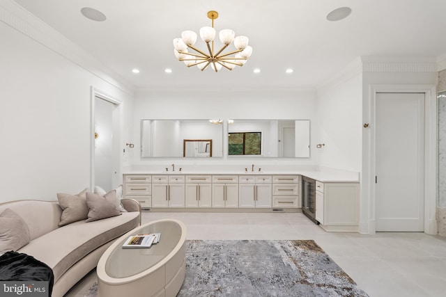 bathroom with wine cooler, vanity, tile patterned flooring, crown molding, and an inviting chandelier