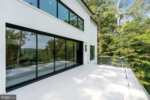 view of side of property with a balcony