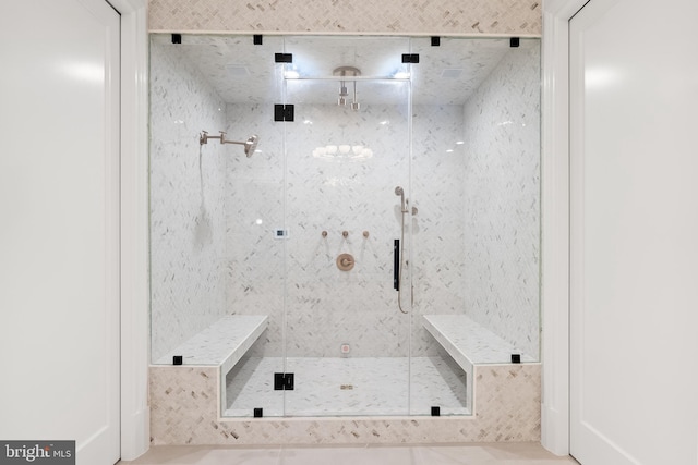 bathroom with tile patterned flooring and a shower with door