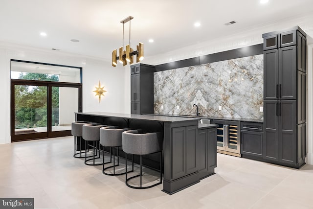 bar with wine cooler, dark stone countertops, pendant lighting, light tile patterned flooring, and crown molding