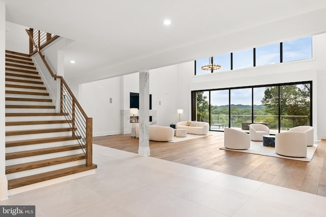 unfurnished living room featuring a notable chandelier