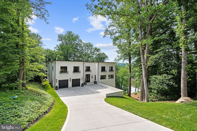 contemporary house featuring a garage and a front yard