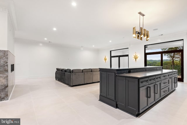 kitchen with hanging light fixtures, light tile patterned flooring, crown molding, and a center island