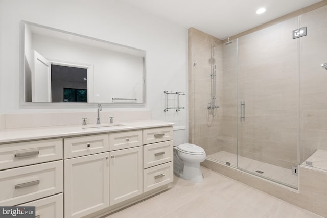 bathroom with an enclosed shower, vanity, toilet, and tile patterned flooring