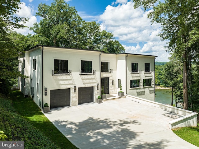 view of front of home with a balcony and a garage