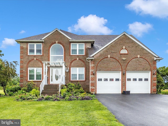 view of front of house with a front yard and a garage