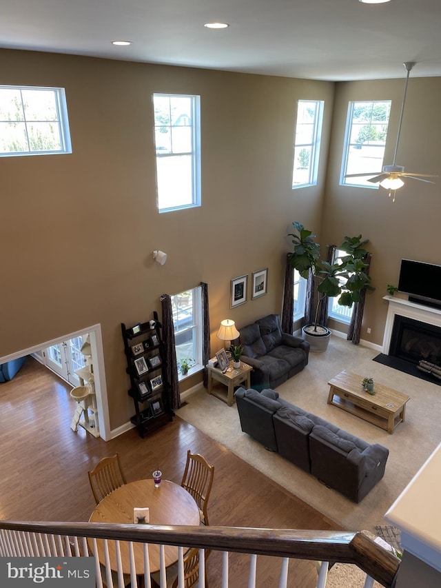 living room with ceiling fan and plenty of natural light